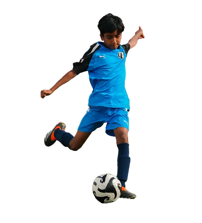 A young boy playing kids football, kicking a soccer ball on a field. Kid Playing Football Soccer Ball in Motion | kids football