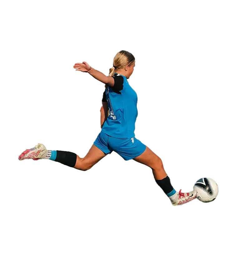 A young girl in blue running on a soccer field at a girls soccer academy. Young Girl Running on Soccer Field | Girls Soccer Academy