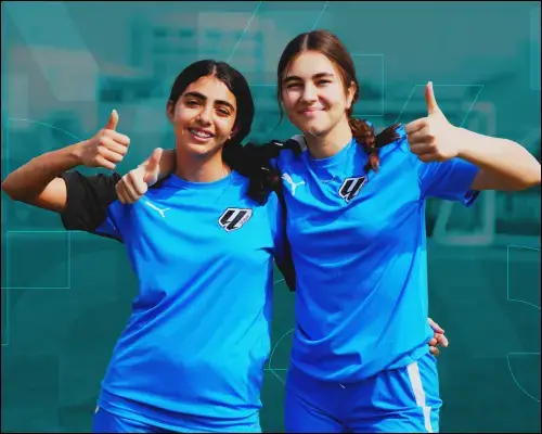Young Female Soccer Players in Action at a Girls Soccer Academy Two Girls in Blue Soccer Uniforms Giving Thumbs Up | Girls Soccer Academy